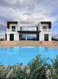 white and brown house near swimming pool