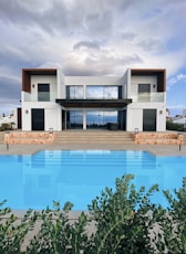 white and brown house near swimming pool