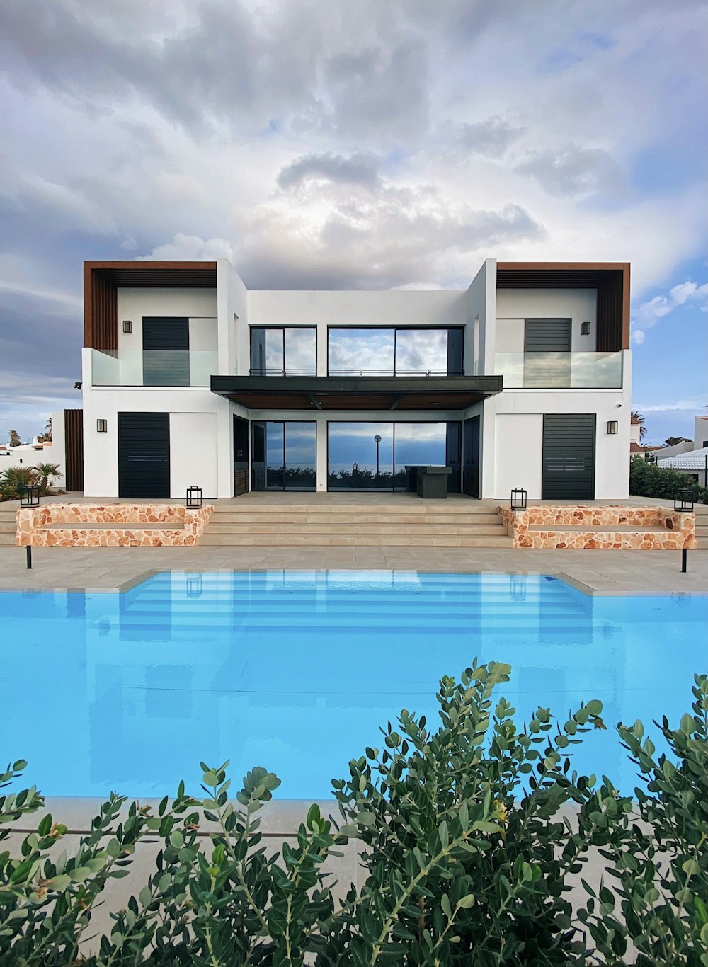 white and brown house near swimming pool