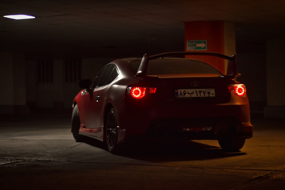 red porsche 911 parked on parking lot during night time