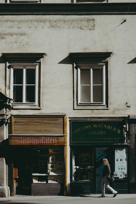 man in black jacket standing in front of store during daytime in Albertina Austria
