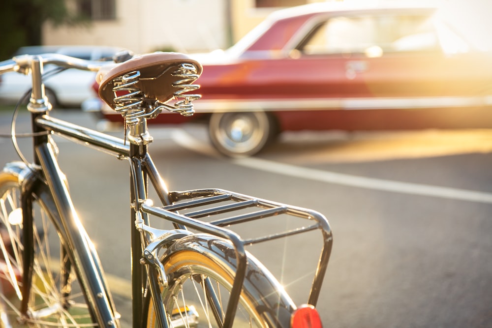 red car parked beside bicycle