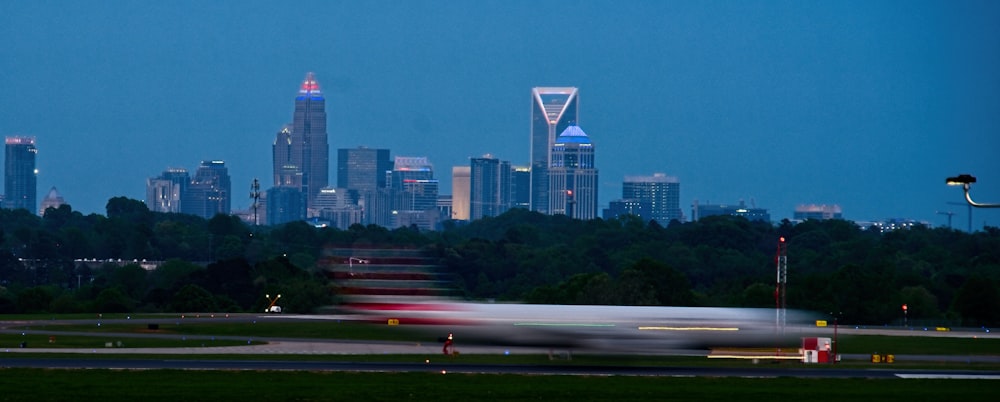 white and red airplane on the city during night time