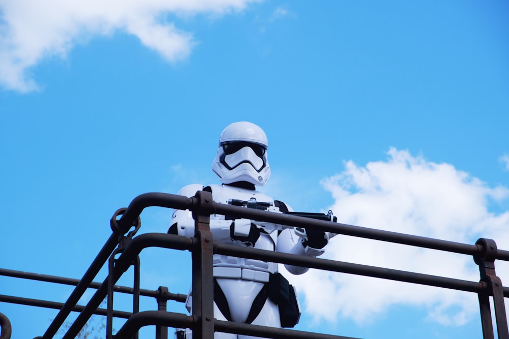 man in white helmet riding on black horse during daytime