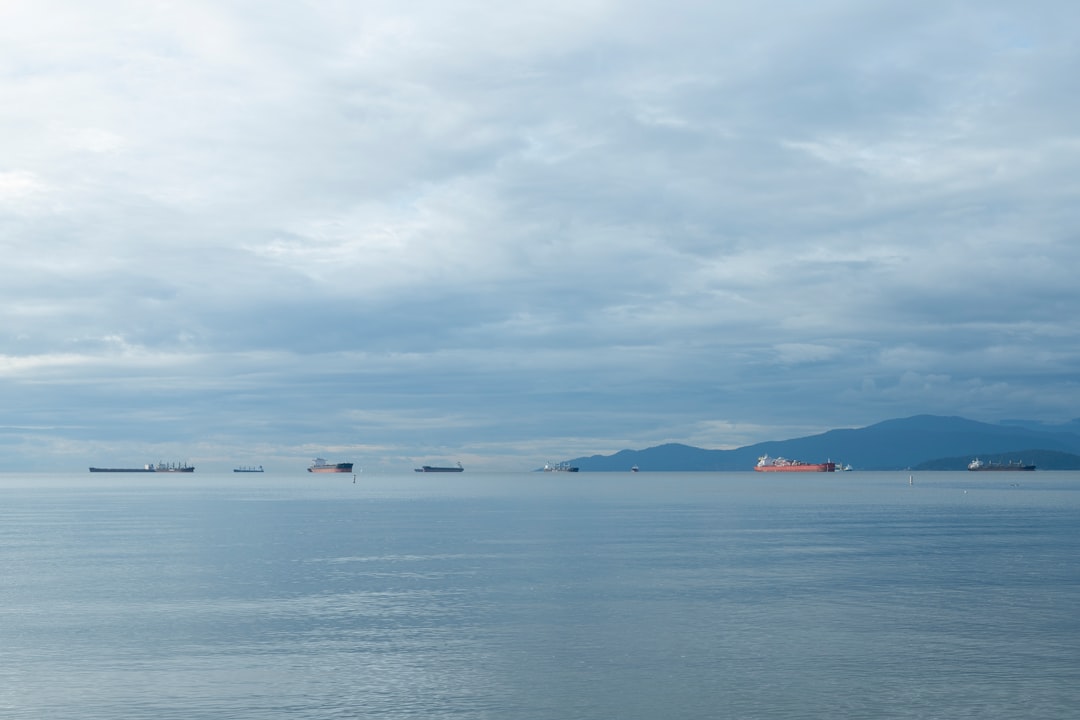 body of water under cloudy sky during daytime