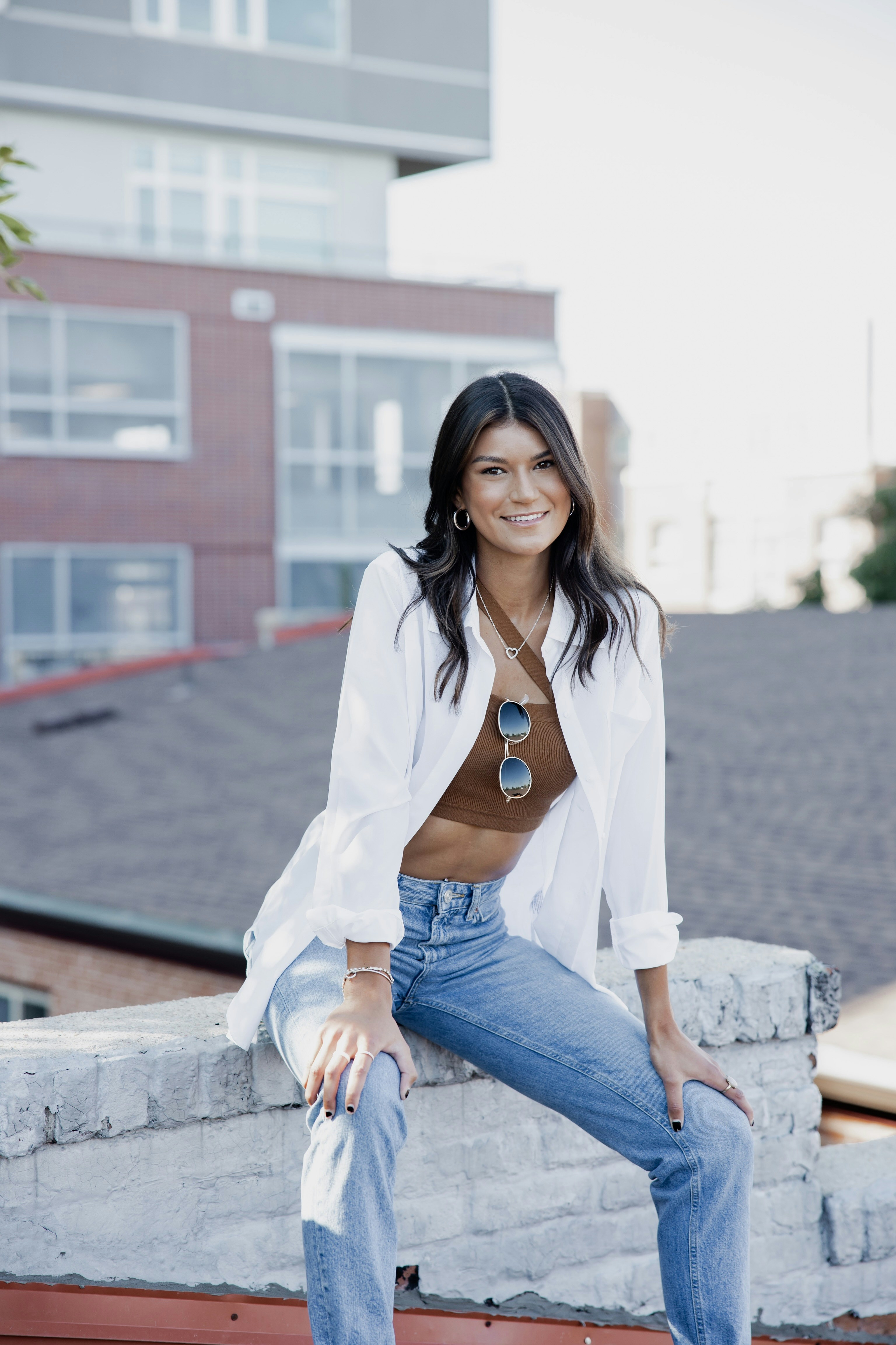 Woman In Black Long Sleeve Shirt And Blue Denim Jeans Sitting On Yellow Couch Photo Free Grey Image On Unsplash