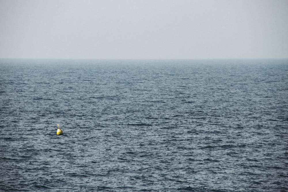 yellow and black boat on sea during daytime