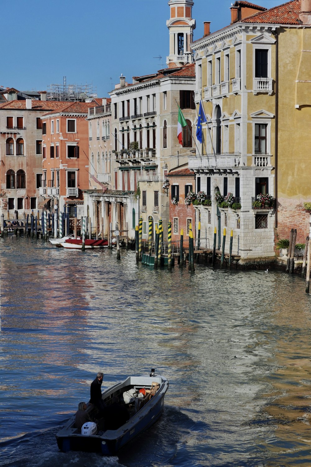 boat on water near buildings during daytime