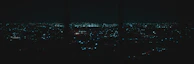A panoramic cityscape at night with digital overlays representing smart technology and AI integration.