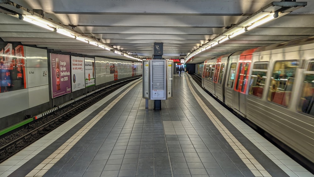 white and red train in train station