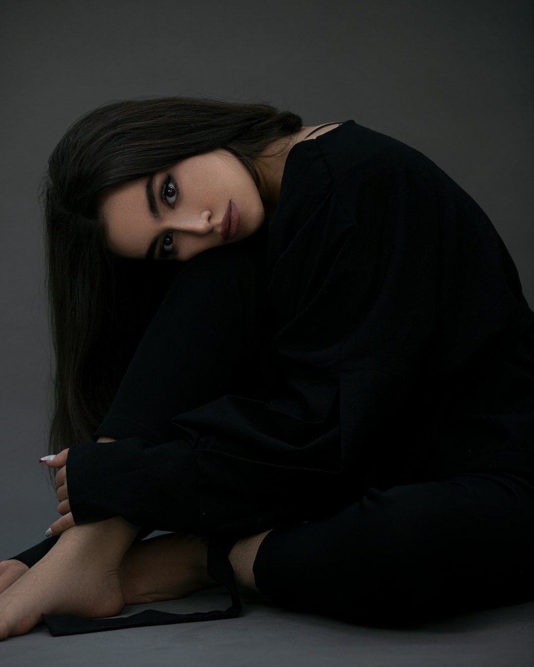 woman in black long sleeve shirt sitting on floor