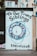 A painted wall with a supportive message for transgender individuals, featuring a circular design with blue and pink hues. The text reads 'To Our Trans Siblings, You Are Not Alone' and includes a website URL at the bottom.