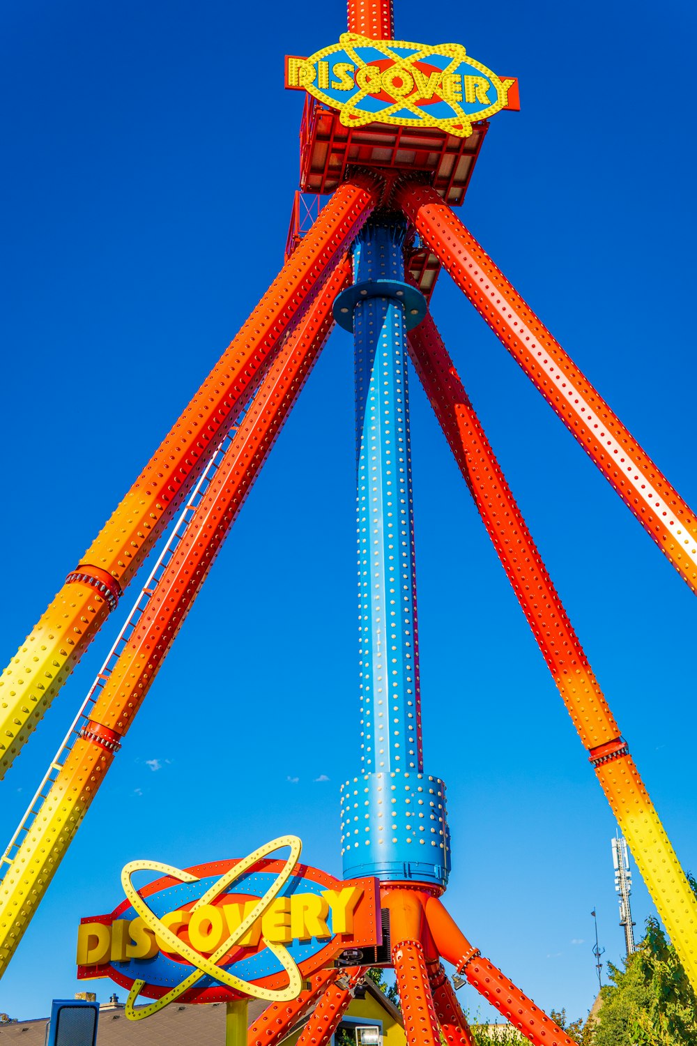 orange and white metal tower under blue sky during daytime