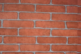 Close-up of skilled mason working on brick wall with precision
