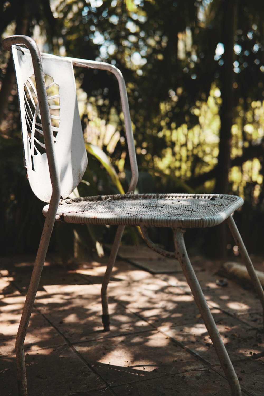 white plastic chair on brown soil