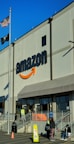 an amazon store with a person sitting in front of it
