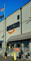 an amazon store with a person sitting in front of it