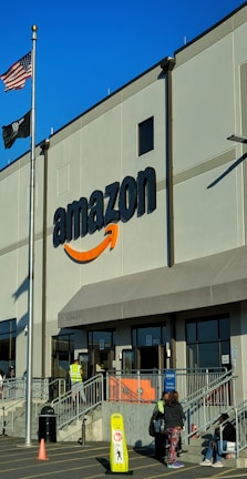 an amazon store with a person sitting in front of it