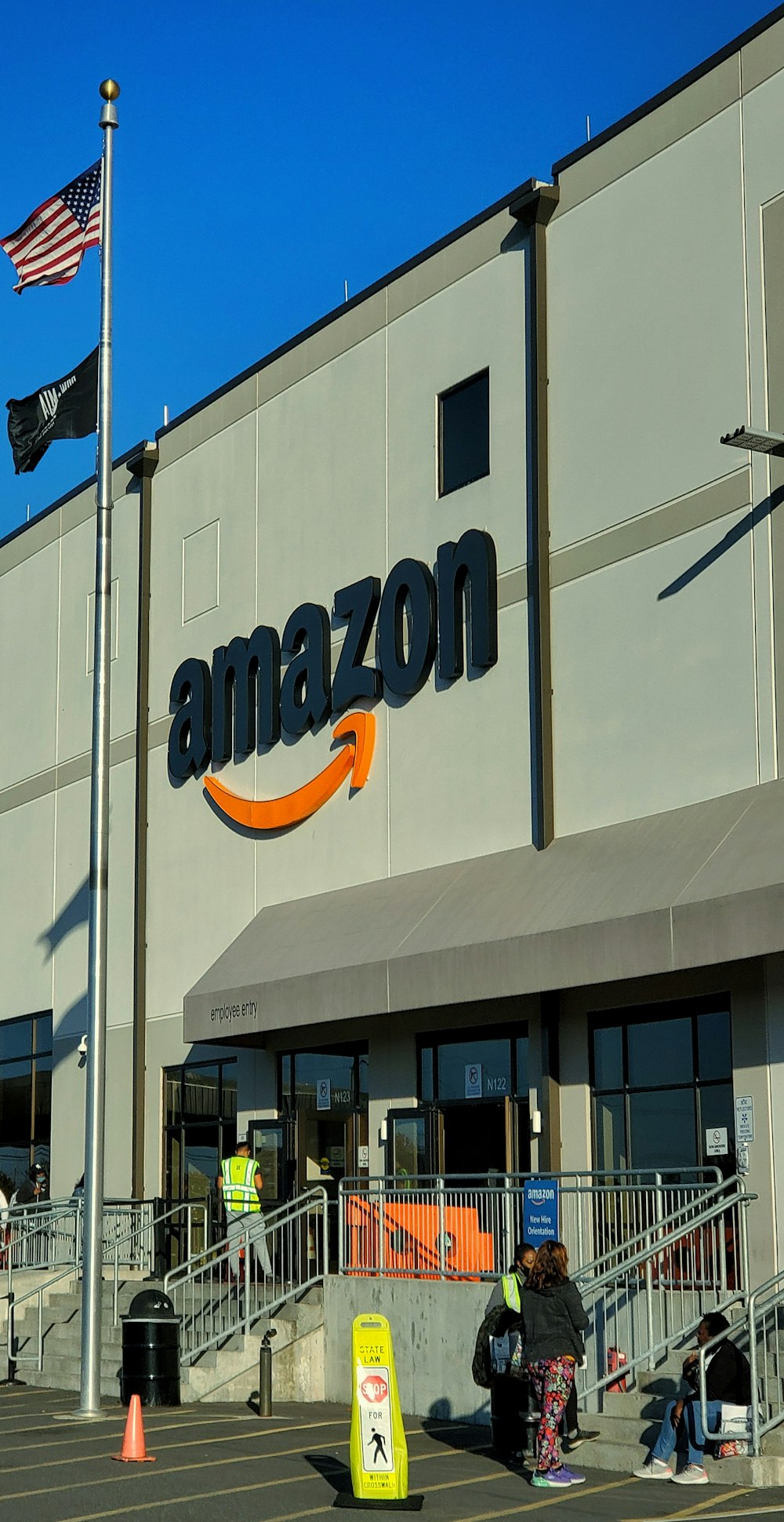 an amazon store with a person sitting in front of it