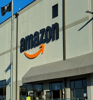 an amazon store with a person sitting in front of it