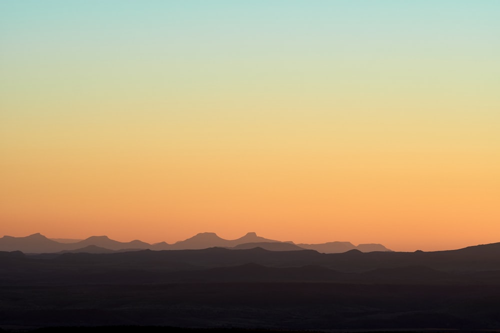 silhouette of mountains during sunset