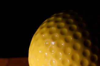 Close-up of a shiny, high-quality PU ball with vibrant colors on a dark sporty background