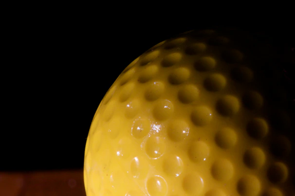 Close-up of a shiny, high-quality PU ball with vibrant colors on a dark sporty background