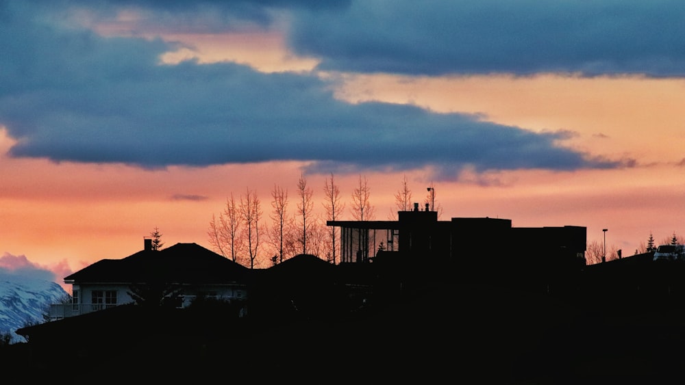 silhouette of houses during sunset