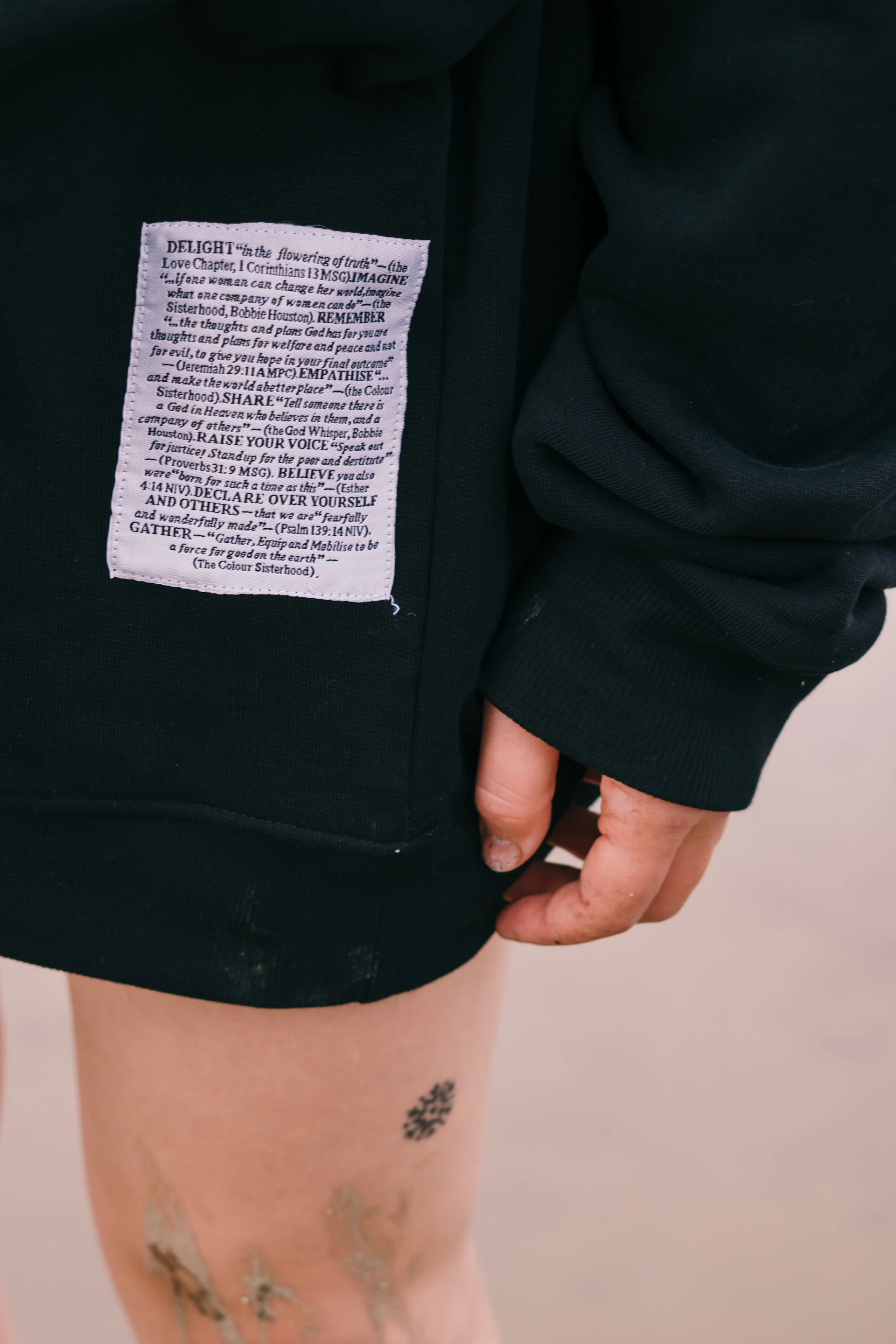 person in black shorts with white printer paper on lap