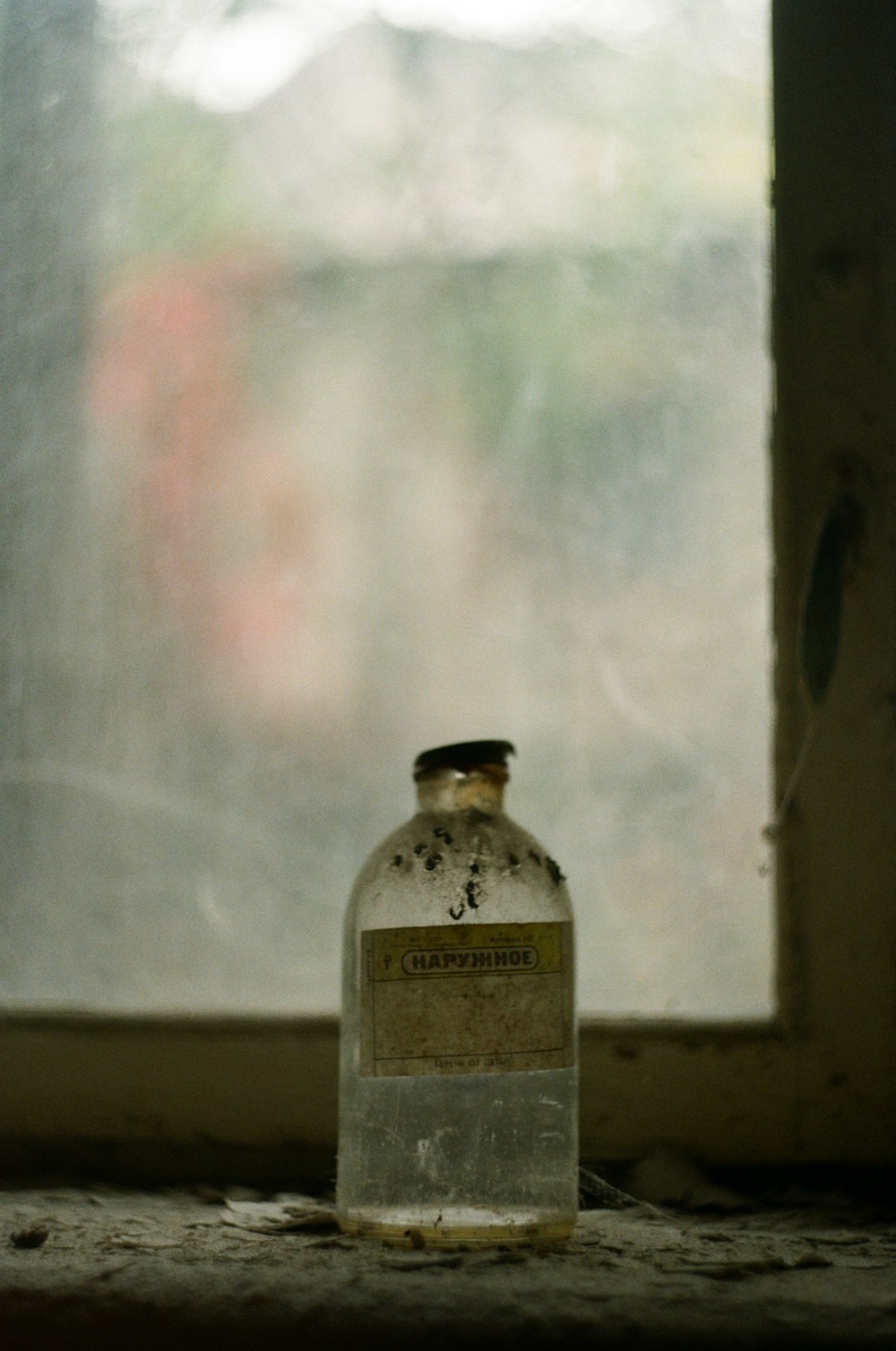 clear glass bottle on brown wooden table