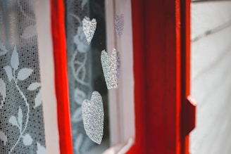 Close-up of a custom-sized maroon curtain bracket installed on an elegant modern window.
