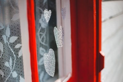 Close-up of a custom-sized maroon curtain bracket installed on an elegant modern window.