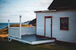 A compact wendy house converted into a cozy home office with a coastal view.
