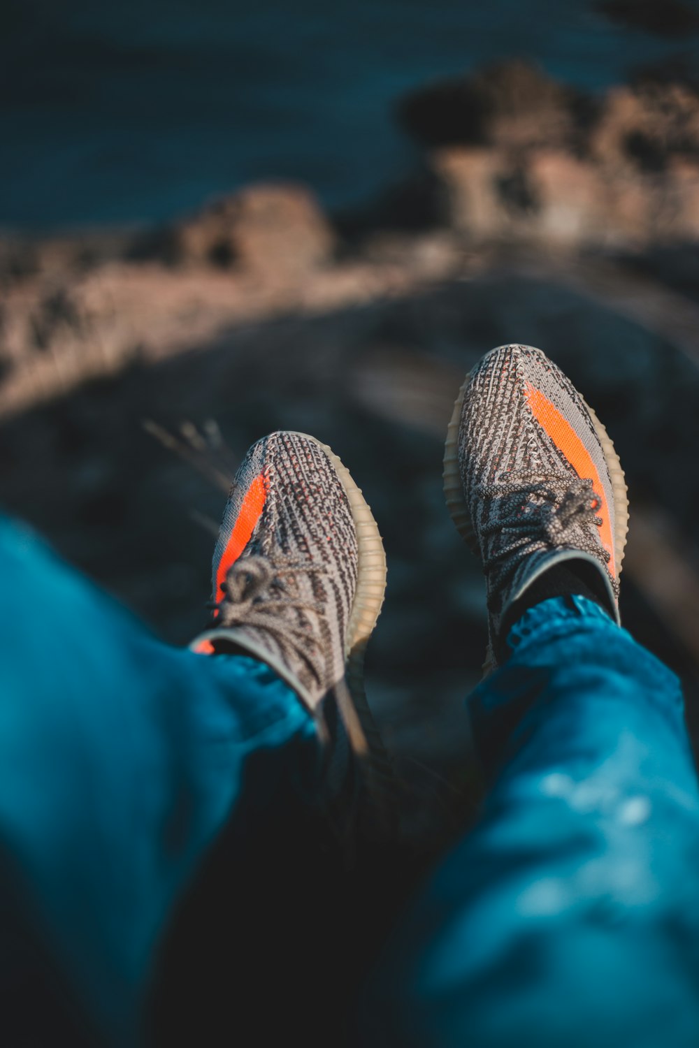 person in blue pants wearing black and white sneakers