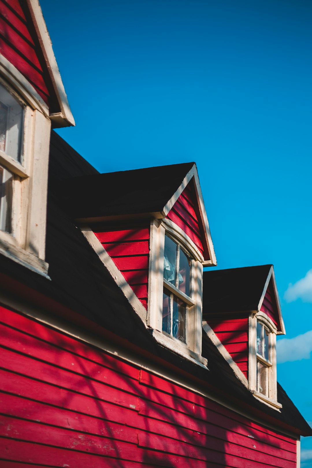 red and white wooden house under blue sky during daytime