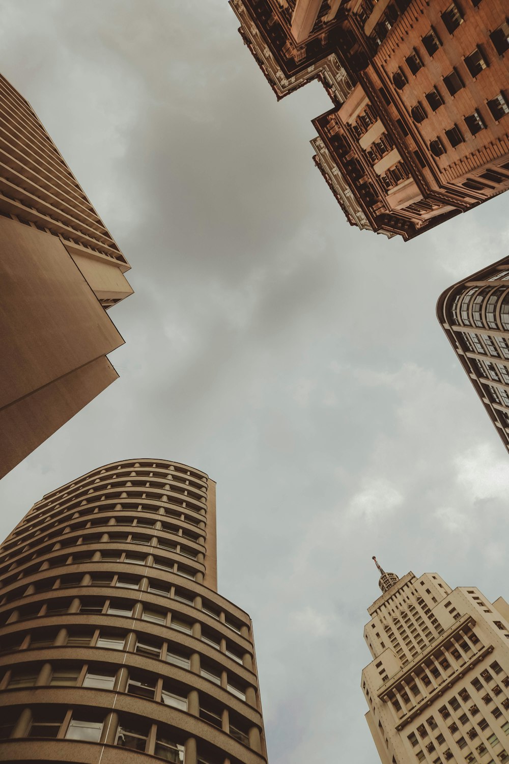 brown concrete building under white clouds during daytime