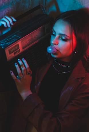 A vibrant 1980s street scene with boombox-wielding dancers, graffiti-covered brick walls, and neon-lit cassette tapes.