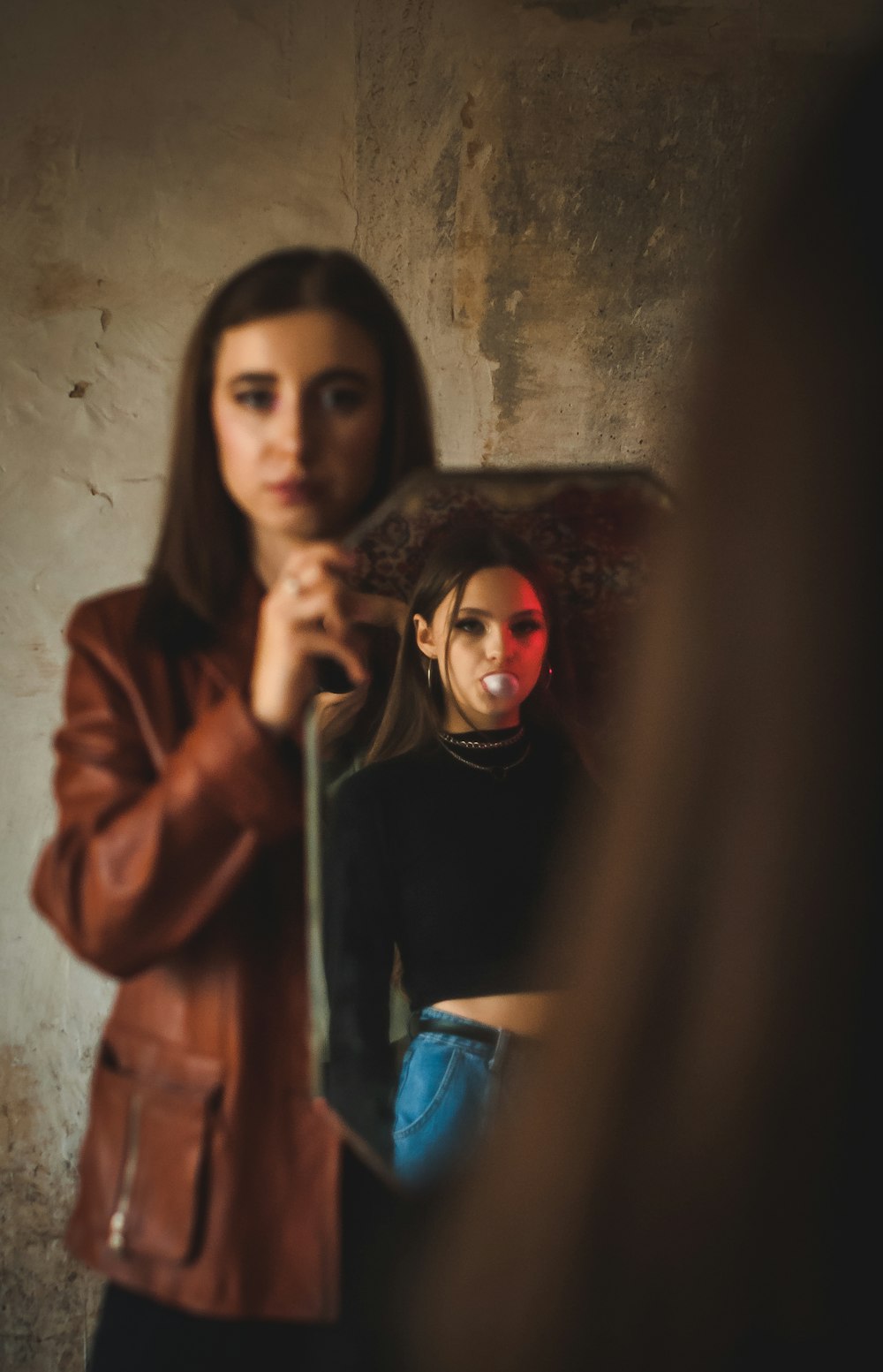 woman in red hoodie holding blue cup