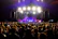 Four-piece band Loud Like Love rocking a lively party crowd with colorful stage lighting.