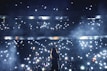 silhouette of person standing on stage with lights