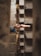 Two hands reaching towards each other between concrete walls, creating a sense of connection amidst a narrow, textured space.