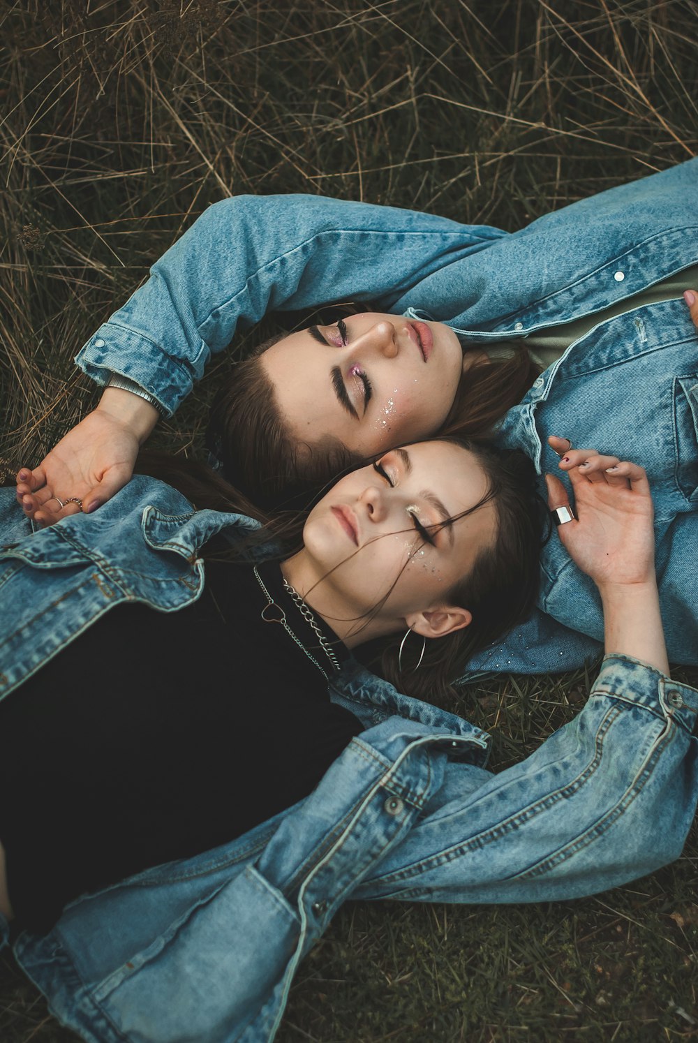 woman in blue denim jacket lying on grass