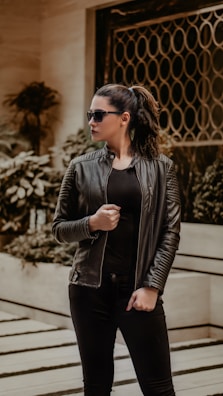 woman in black leather jacket wearing black sunglasses