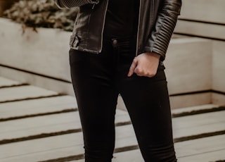 woman in black leather jacket wearing black sunglasses