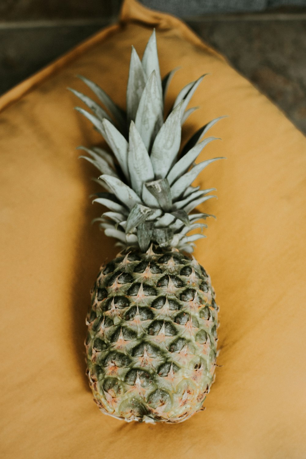 pineapple fruit on brown textile