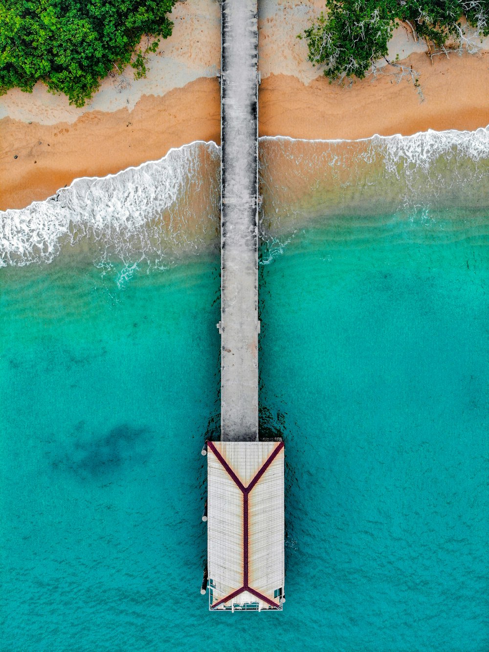 brown wooden dock on blue body of water during daytime