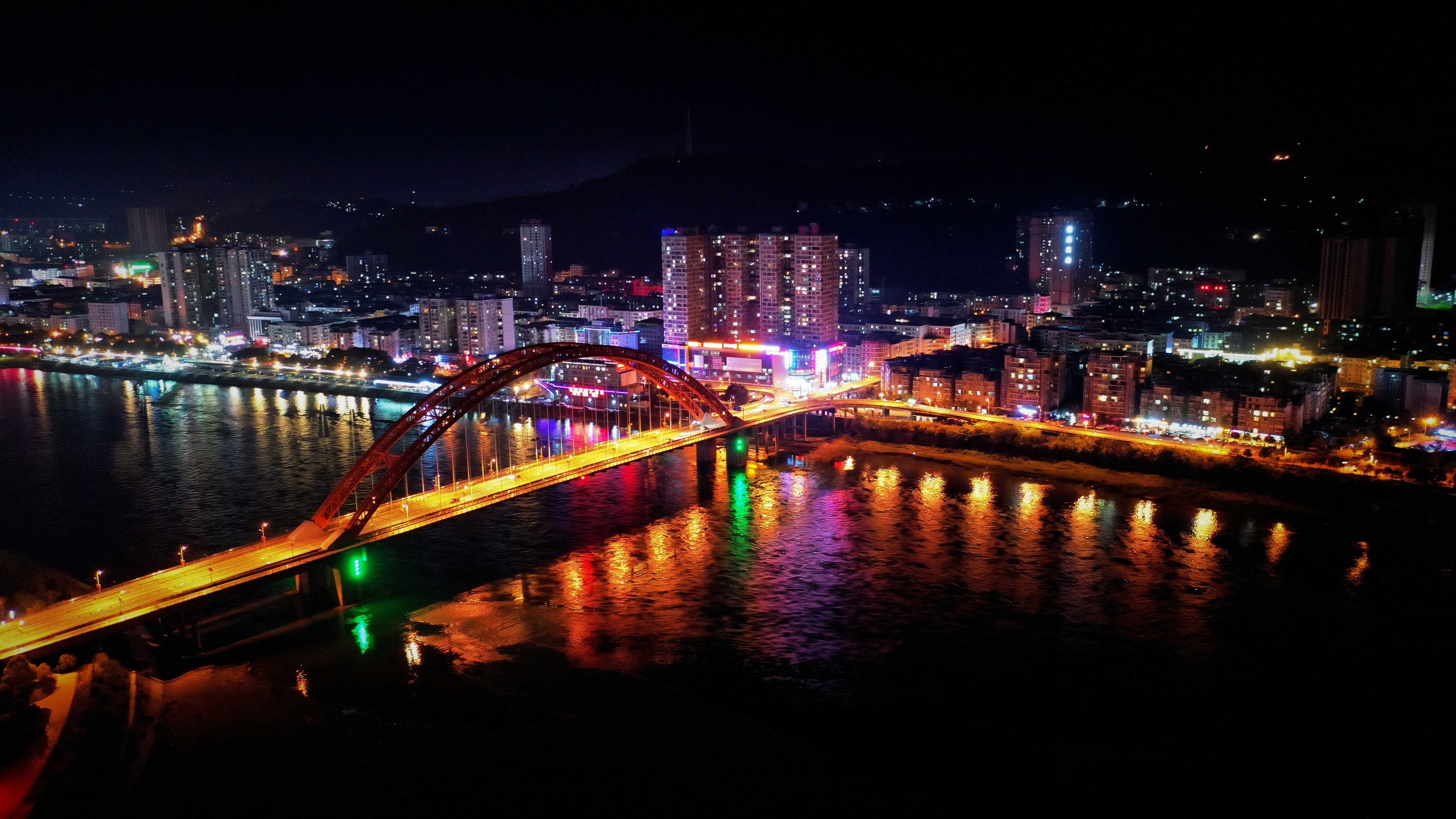 bridge over body of water during night time