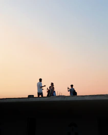people standing on concrete wall during daytime