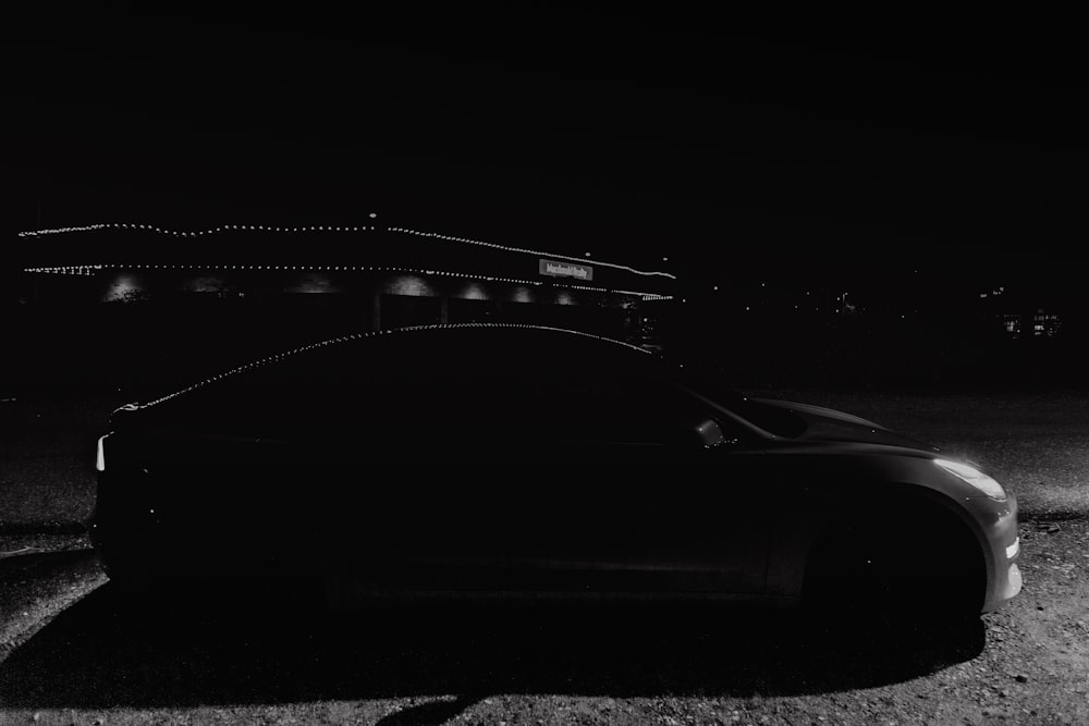 red car on black asphalt road during night time