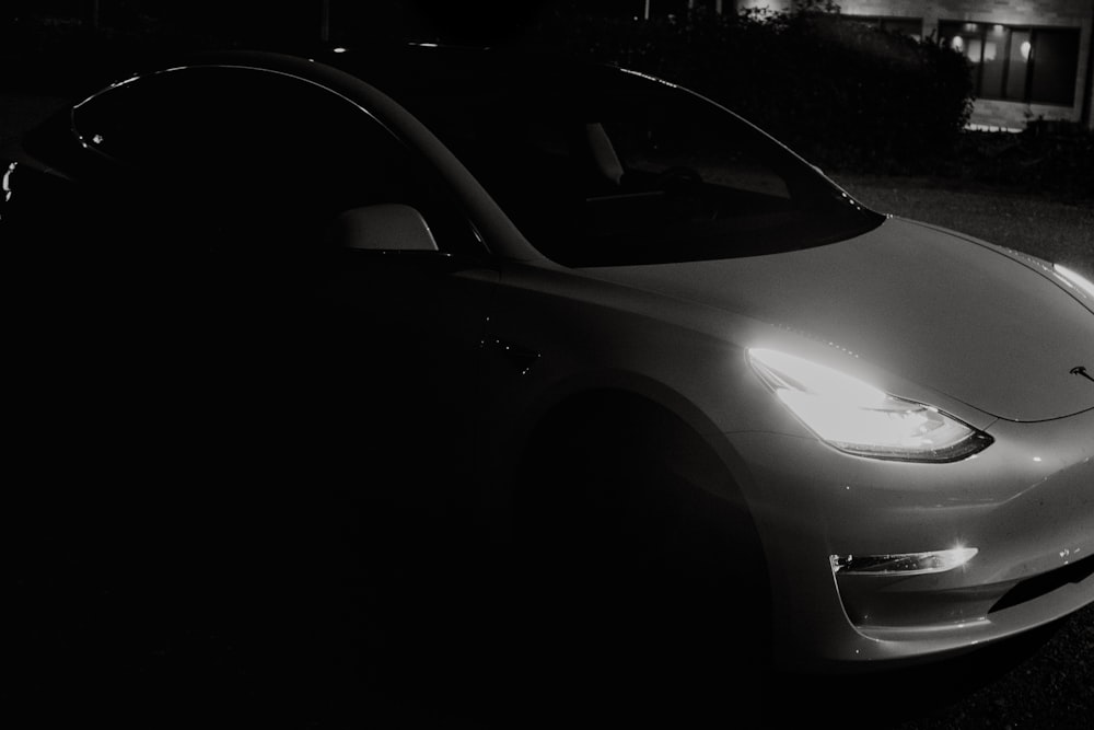 white car on black asphalt road during night time